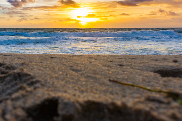 ground view of a sandy beach shore just after sunrise
