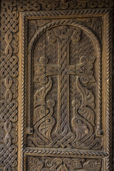 Fototapeta na wymiar Decorative wooden door to the church of Saint Hripsime in Etchmiadzin.