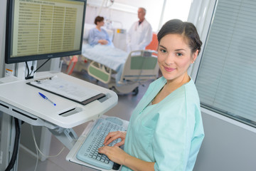 Fototapeta premium happy female doctor at the computer in hospital room