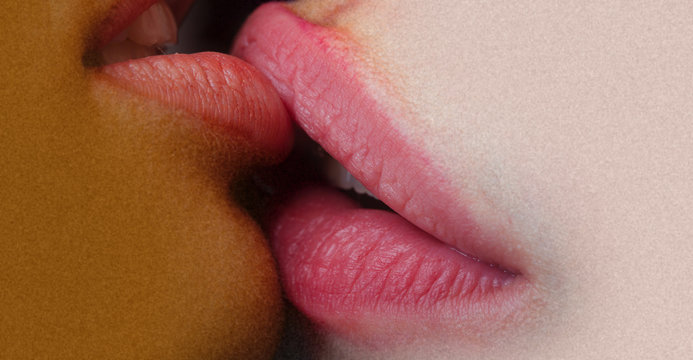 Lesbian lips together. Passionate kiss. Female lips closeup. Girls lesbians. Closeup of pair women mouths kissing. Homosexual couple love