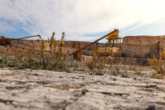 Former stone quarry with abandoned crusher and conveyor machines. Apulia region, Italy.