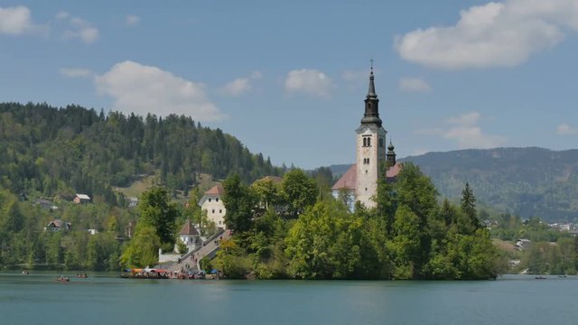 Island with Catholic Church at Bled Lake in Slovenia Alps 4K UHD Timelapse. Bled lake castle and island is an Iconic Slovenia Touristic place with terme and hotel where Tourists can rowing and boating