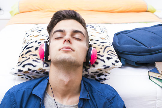 young teenager listening to music with headphones and mobile phone