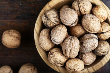 walnuts in a wooden plate top view