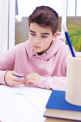 adolescent student on the desk studying and writing