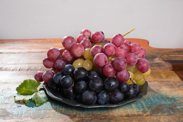 Large organic table grape Globe in assortment served on the tin plate