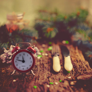 Christmas concept.The time of the gala dinner. Alarm clock Cutle