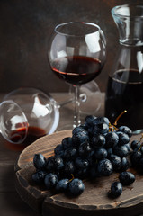 Fresh Black Grapes and Red Wine on Wooden Table Selective Focus