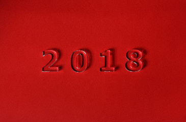 Fototapeta na wymiar New year 2018 is red background with the numbers of clear acrylic look like glass.