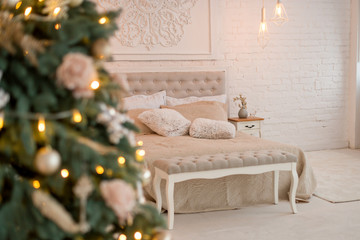 New Year's interior. Christmas tree bed with soft beige back and decorative pillows. Concept happy Cristmas