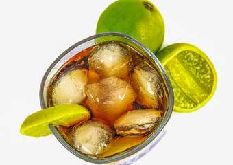 Fresh cocktail with whisky, cola drink and lime fruit