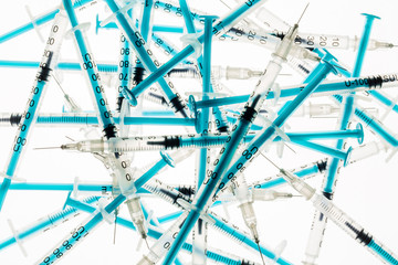 A lot of transparent medical syringes. Close up shot, white background.