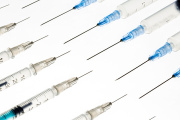 A lot of transparent medical syringes. Close up shot, white background.