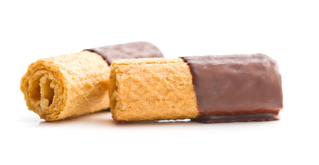 Sweet dessert. Biscuits rolls with chocolate icing.