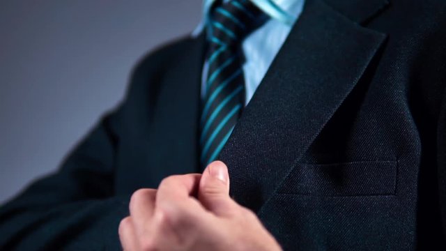 slow motion, businessman pulls the phone out of his jacket pocket