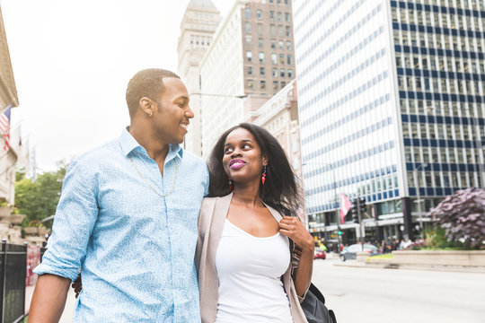 Happy black couple walking in Chicago