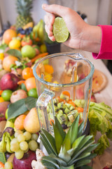 Blender and lime fruit in hand