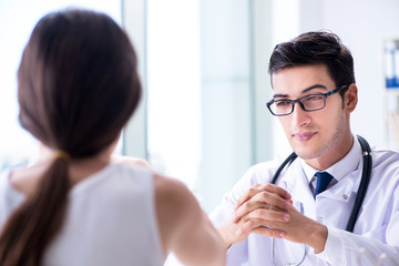 Woman with pet rabbit visiting vet doctor