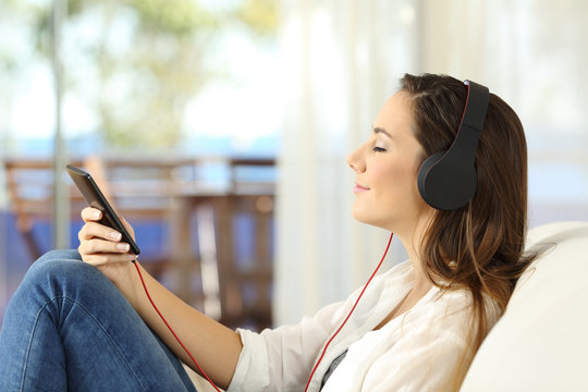Profile of a woman relaxing listening music