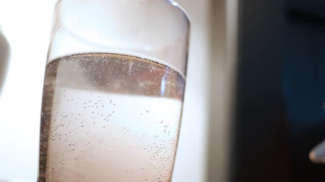 Old Glass of Water on bedstand developing stale flat bubbles