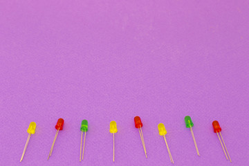 Set of colorful cables and diodes on violet background