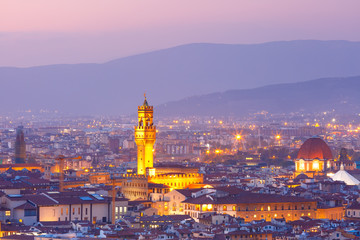 Fototapeta na wymiar Famous Arnolfo tower of Palazzo Vecchio on the Piazza della Signoria at beautiful sunset in Florence, Tuscany, Italy
