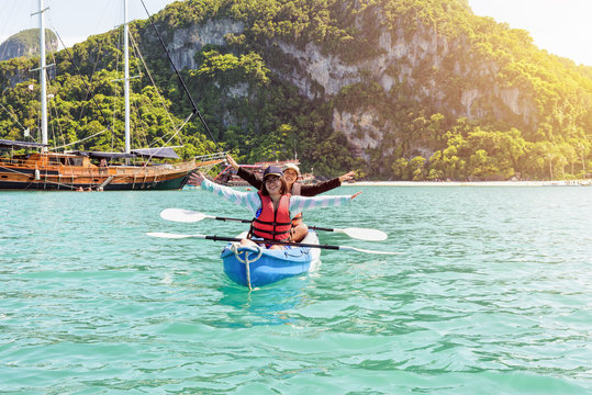 Two women are mother and daughter. Travel by boat with a kayak happy on the sea under the bright summer sky front of Ko Wua Ta lap islands at Mu Ko Ang Thong National Park, Surat Thani, Thailand