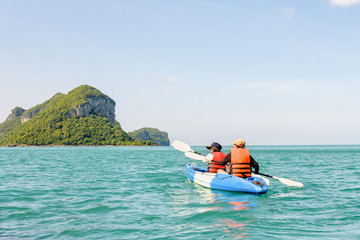 Two women are mother and daughter. Travel by boat with a kayak summer around Ko Phi view the beautiful nature of the sea and island, Mu Ko Ang Thong National Park, Surat Thani, Thailand