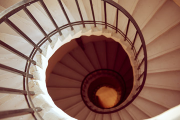 View to the circle spiral staircase in old building