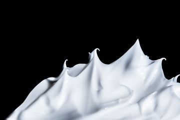 White cosmetic cream close-up macro texture background isolated on black