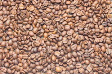 Top view of coffee beans on rustic wooden table