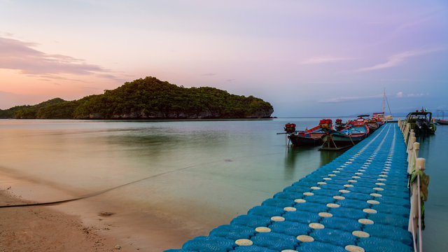 Floating bridge pier for tourist on the beach in front of Ko Wua Ta Lap island view Ko Phi during sunset at Mu Ko Ang Thong National Marine Park in Gulf of Thailand, Surat Thani province