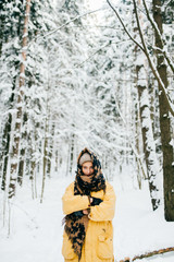 Lovely girl with angelic beautiful face. Odd bizarre person. Kinky female in winter snowy forest freezing and covering with warm clothing. Emotional lady eyes looking. Happy smiling blonde traveler.