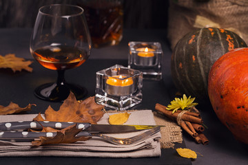 Table setting with autumn decoration for Thanksgiving.