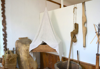 old cradle, rocker, trough, spinning wheel, bast shoes, vintage household items and interior