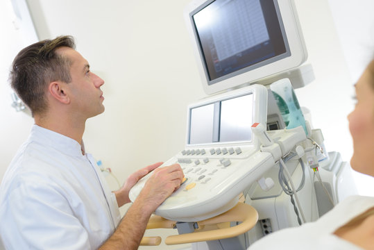 doctor examining patients echograph
