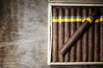 Large box of Cuban cigars on a wooden table