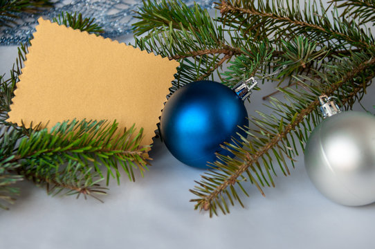 Blue and silver ball on a spruce branch, gold postcard