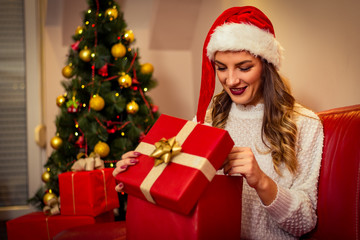Woman opening gift box. Christmas time