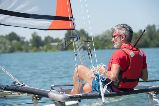 sailing man on sailboat during competition