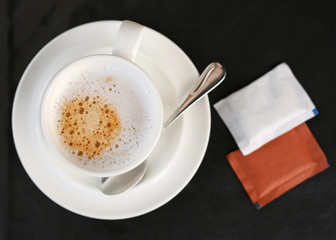 Top view Cup of espresso coffee on the black table.