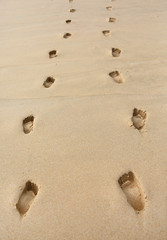 Fototapeta na wymiar Footprints in the sand background.