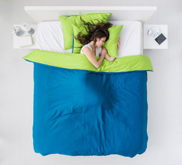 Woman sleeping in her bedroom