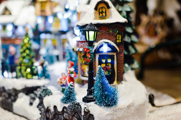 Decorated Christmas children shopping toys on joyful festive shiny blurred light background, closeup image. Seasonal elegant natural classy mood, love peace jolly decor design, traditional bright joy