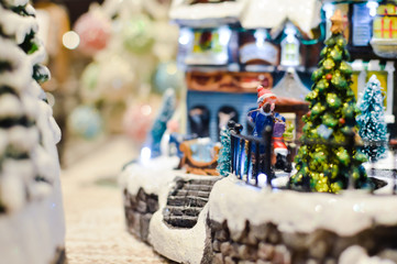 Decorated Christmas children shopping toys on joyful festive shiny blurred light background, closeup image. Seasonal elegant natural classy mood, love peace jolly decor design, traditional bright joy