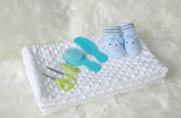 Collection of items for newborn babies on the bed.