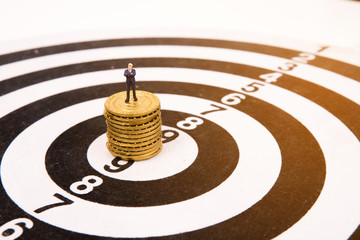 business miniature people  standing on dartboard and gold coin,business concept