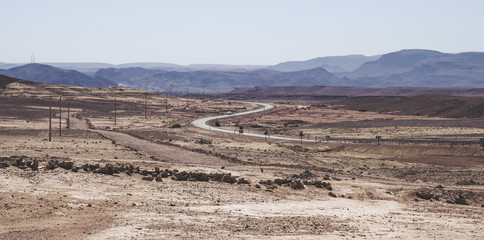 Desert road with Atlas Mountains near Kasbah Ait Ben Haddou, Morocco