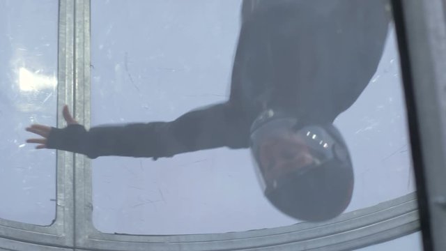 Professional skydiver flying in wind tunnel. Training jumping with a parachute