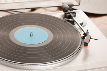 Moving magnet cartridge on the tonearm standing on a vinyl record